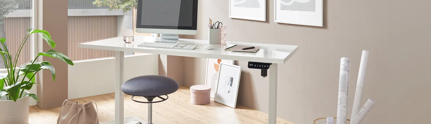 weißer Schreibtisch mit Bildschirm, Tastatur, Arbeitsmaterial, Deko in einem Arbeitszimmer