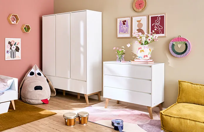 Weiße Kommode und passender Kleiderschrank von pinio, Sitzsessel in Senfgelb und Sitzsack als Hund
