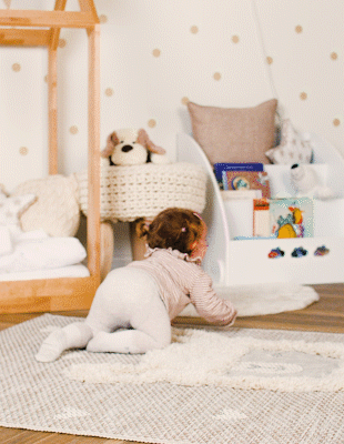 Kind krabbelt über Teppich