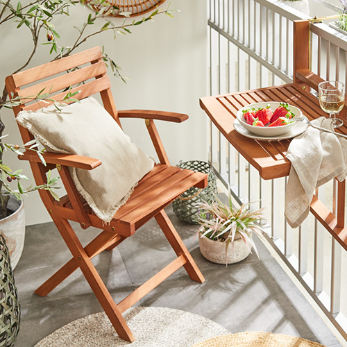 Holz-Klappstuhl auf einem Balkon mit passendem Hänge-Tisch am Balkongeländer
